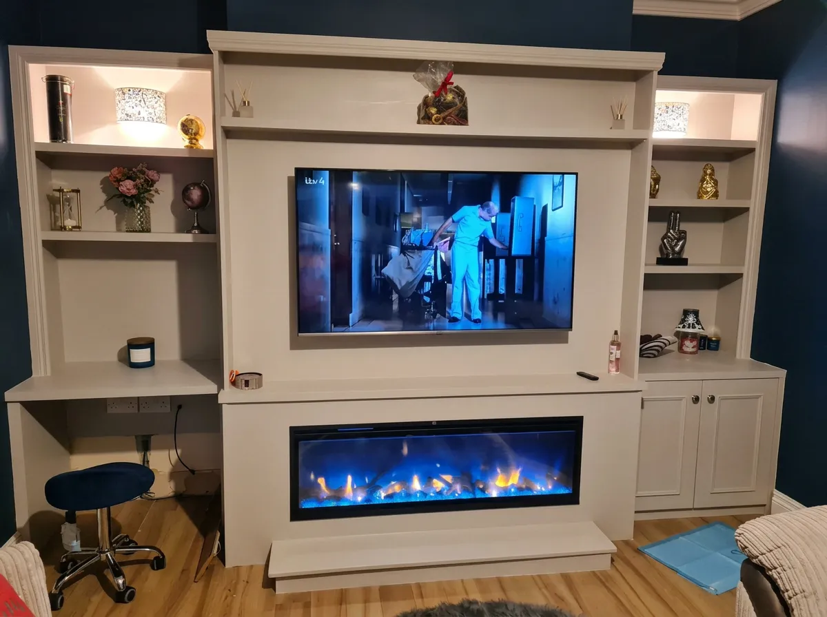 Stone-coloured media wall with lit shelving, an integrated desk and a wide inset fire